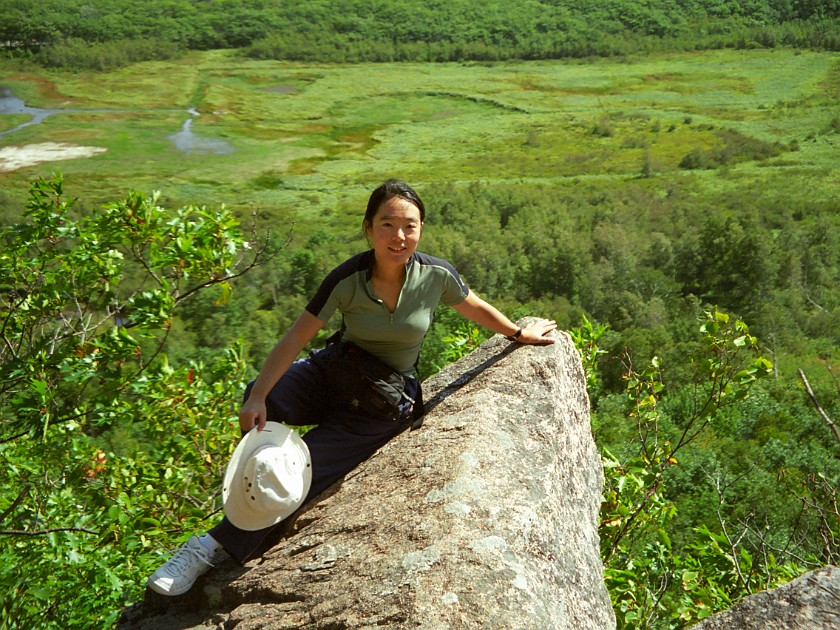 Climbing to the Top of Mount Champlain. Portrait on Rock. Arcadia National Park. .