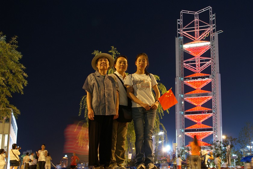 Night at the Olympic Green. Mother and niece in front of the Linglong Tower. Beijing. .