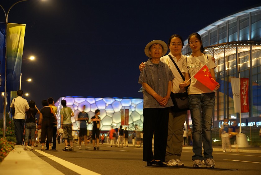 Night at the Olympic Green. Mother and niece in front of the National Indoor Stadium. Beijing. .