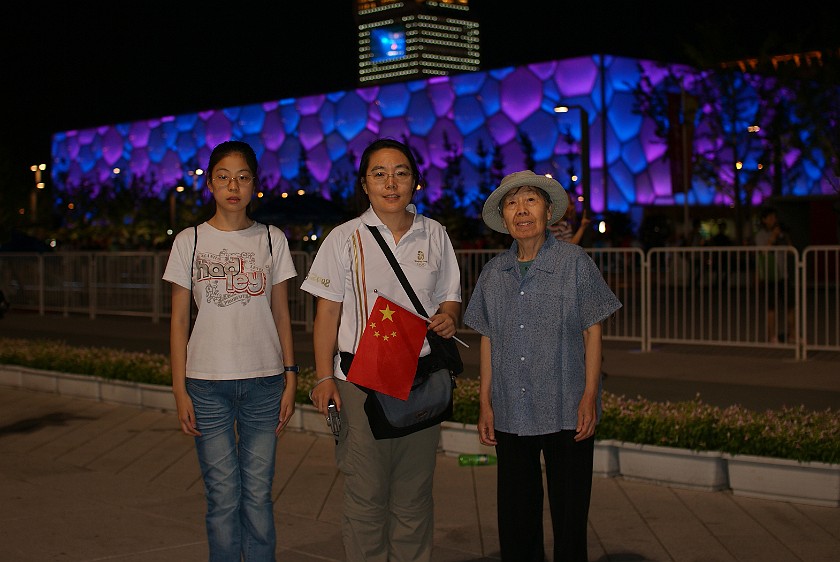 Night at the Olympic Green. Mother and niece in front of the National Aquatics Center. Beijing. .