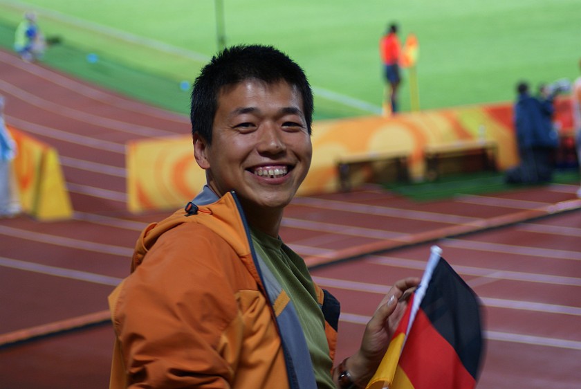 Women's Football Bronze Match Germany vs Japan. Chinese spectator cheering for Germany. Beijing. .