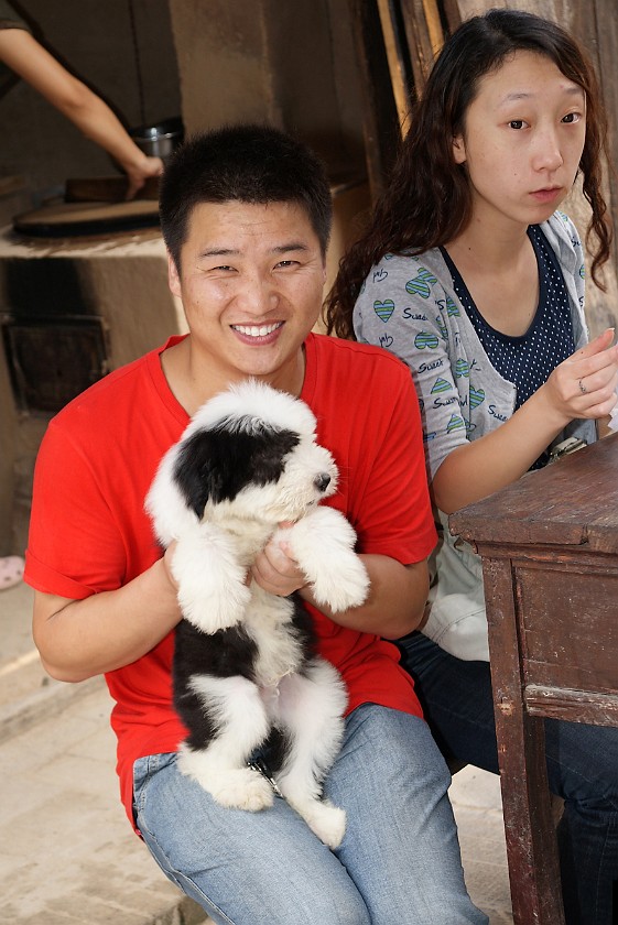 Liquan Yuan Village. Man with Puppy. Liquan Yuan. .