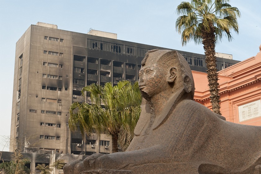 Egyptian Museum. Sphinx and burned out party headquarter building. Cairo. .