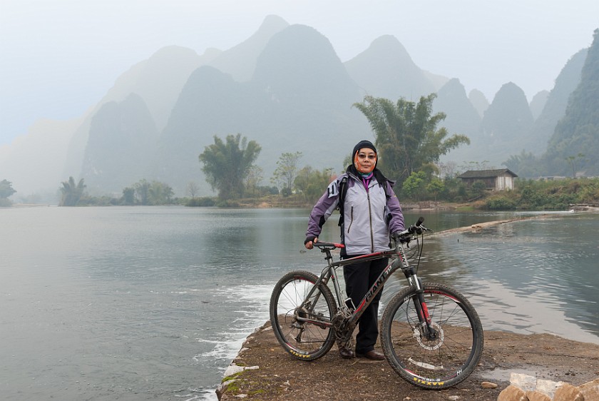 Bicycle Tour Along the Yùlóng Hé River. Portrait at a barrage. Yángshuò. .