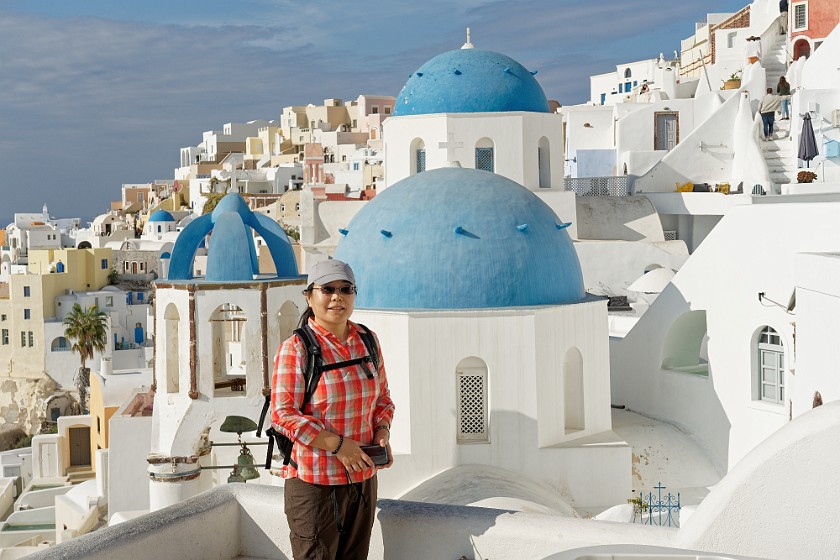 Oia, Santorini. Portrait in front of the churches of Saint Spyridon and Resurrection of the Lord. Oia. .